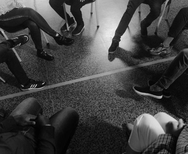 Group therapy session with people sharing different perspectives and bonding over shared experiences.