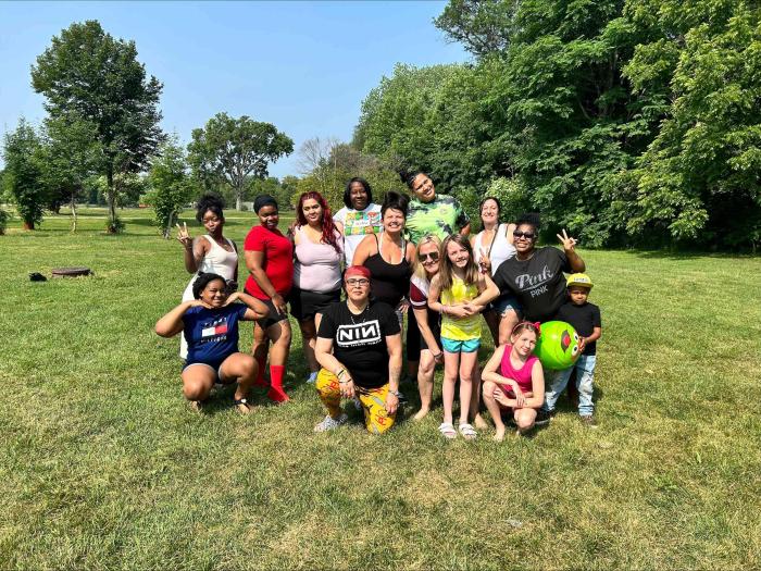 Group of families enjoying time at the apple orchard with RS EDEN.