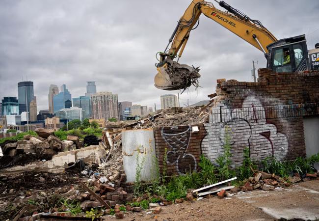 Construction crane removing building rubble.
