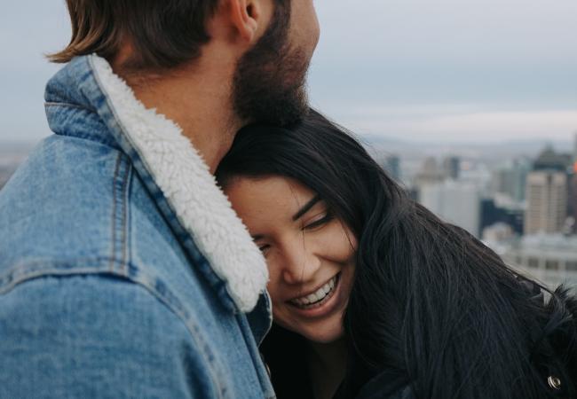 A couple hugging happily.
