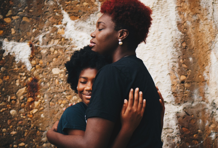 Parent and child hugging in reconciliation.